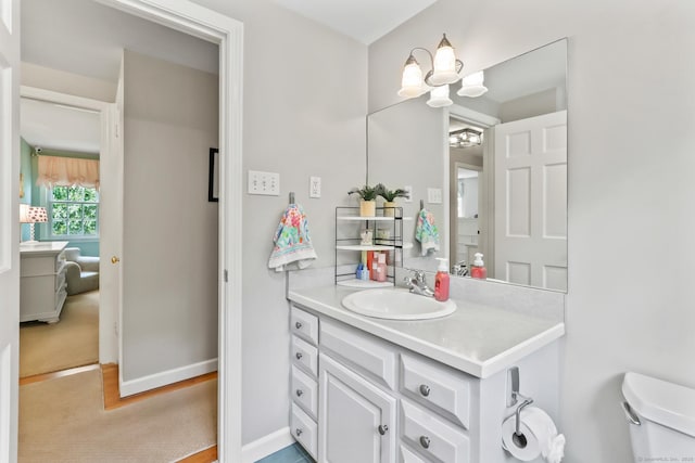 17 Stockade Rd, Simsbury, CT 06092 - bathroom featuring vanity, a chandelier, toilet, and baseboards