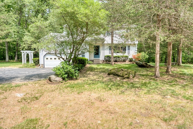 24 Marbella Ln, Tolland, CT 06084 - view of property hidden behind natural elements with asphalt driveway and a front yard