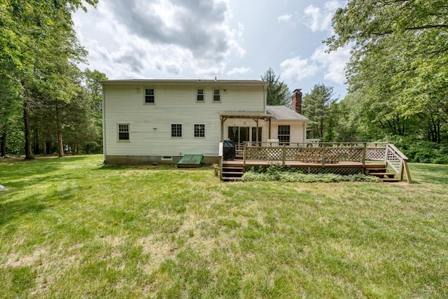 24 Marbella Ln, Tolland, CT 06084 - back of property with a wooden deck, a chimney, and a yard