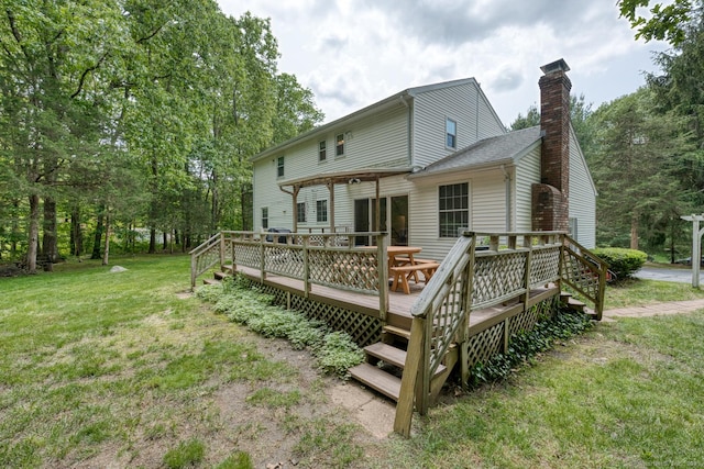 24 Marbella Ln, Tolland, CT 06084 - rear view of house with a yard, a chimney, and a wooden deck