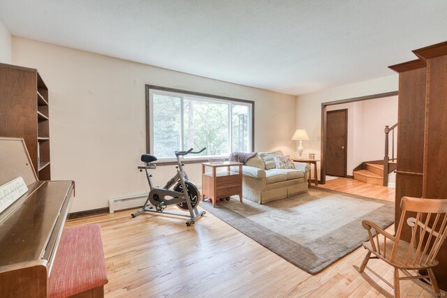 24 Marbella Ln, Tolland, CT 06084 - exercise room with light wood-style flooring and a baseboard heating unit