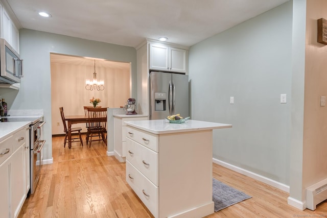24 Marbella Ln, Tolland, CT 06084 - kitchen featuring stainless steel appliances, light wood-style flooring, white cabinets, light countertops, and recessed lighting