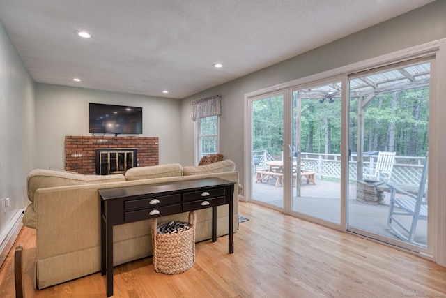 24 Marbella Ln, Tolland, CT 06084 - living room with light wood-style flooring, a fireplace, and recessed lighting