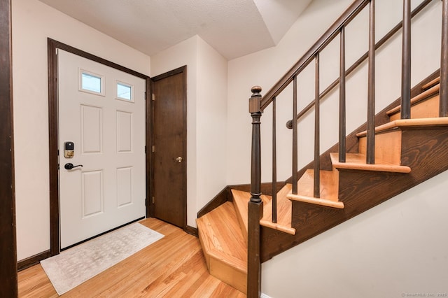 24 Marbella Ln, Tolland, CT 06084 - entrance foyer with light wood-type flooring, stairway, and baseboards