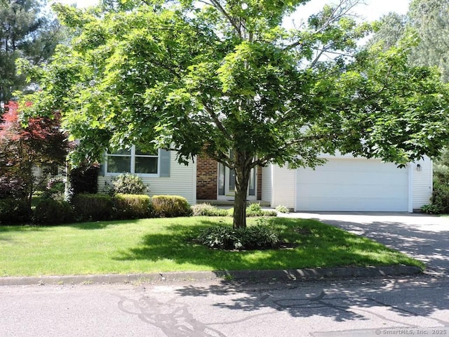 2 Abbewood Dr Unit 2, Enfield, CT 06082 - obstructed view of property featuring concrete driveway, a front yard, and an attached garage