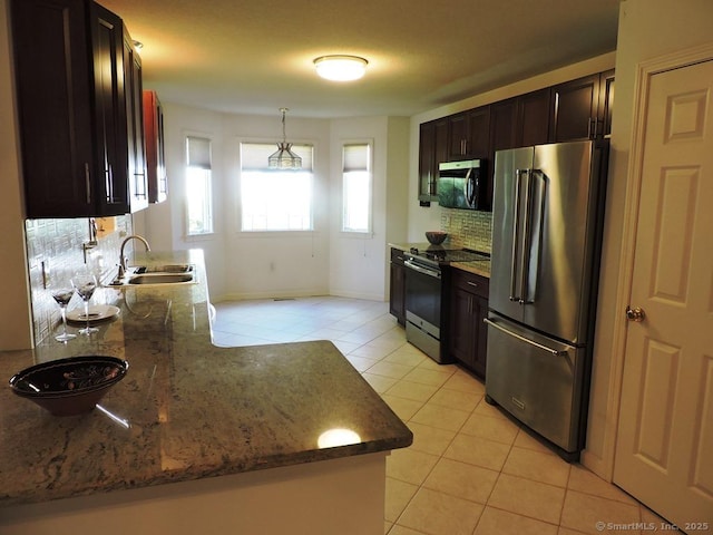 2 Abbewood Dr Unit 2, Enfield, CT 06082 - kitchen featuring appliances with stainless steel finishes, a sink, light tile patterned flooring, decorative backsplash, and stone counters