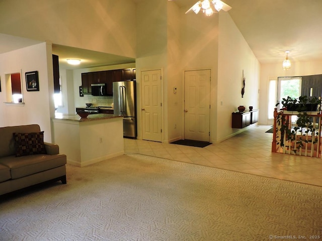 2 Abbewood Dr Unit 2, Enfield, CT 06082 - living room featuring light tile patterned flooring, a towering ceiling, ceiling fan, baseboards, and light carpet