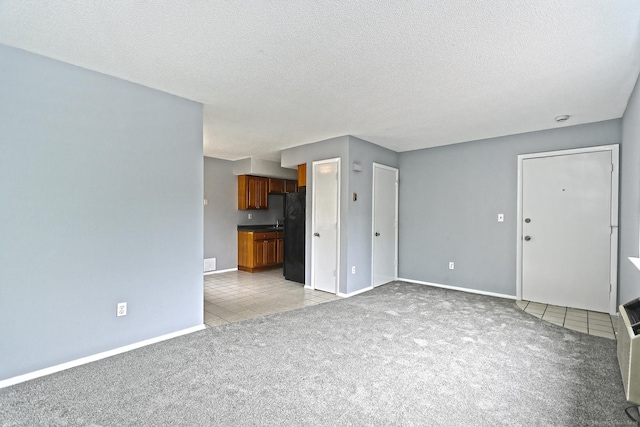 60 Plainfield Ave Unit 14, West Haven, CT 06516 - unfurnished living room with light carpet, light tile patterned flooring, baseboards, and a textured ceiling