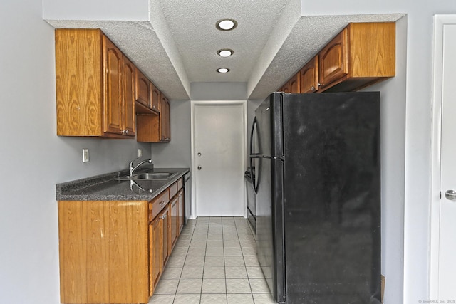60 Plainfield Ave Unit 14, West Haven, CT 06516 - kitchen with freestanding refrigerator, a sink, a textured ceiling, dark countertops, and light tile patterned flooring