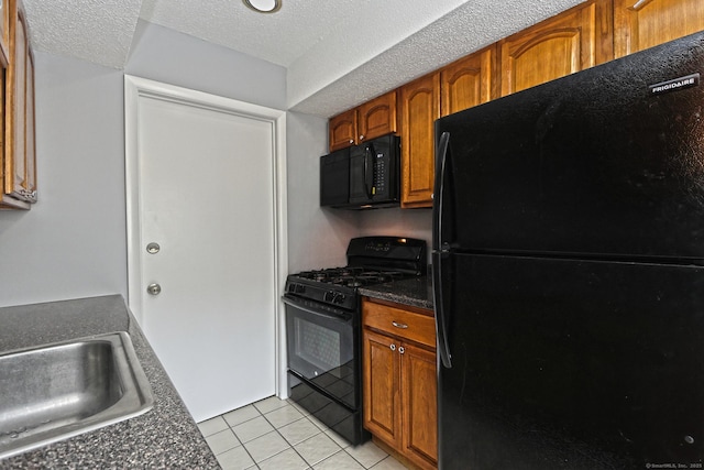 60 Plainfield Ave Unit 14, West Haven, CT 06516 - kitchen featuring black appliances, a sink, dark countertops, light tile patterned floors, and brown cabinets
