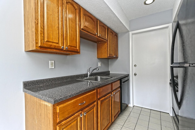 60 Plainfield Ave Unit 14, West Haven, CT 06516 - kitchen featuring freestanding refrigerator, a sink, dishwashing machine, light tile patterned floors, and brown cabinets