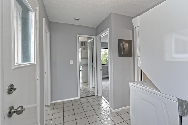 60 Plainfield Ave Unit 14, West Haven, CT 06516 - corridor featuring electric panel, baseboards, light tile patterned floors, a textured ceiling, and stacked washer / drying machine
