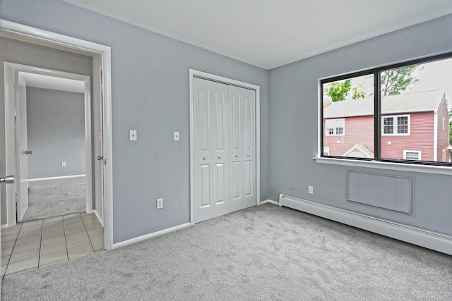 60 Plainfield Ave Unit 14, West Haven, CT 06516 - unfurnished bedroom featuring carpet flooring, a baseboard radiator, baseboards, a closet, and tile patterned flooring