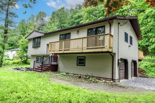 4 Deer Run Trl, Sherman, CT 06784 - rear view of house with a balcony, an attached garage, driveway, and view of scattered trees