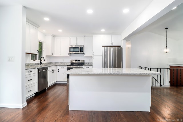 4 Deer Run Trl, Sherman, CT 06784 - kitchen with stainless steel appliances, a kitchen island, white cabinetry, dark wood-style floors, and light stone counters
