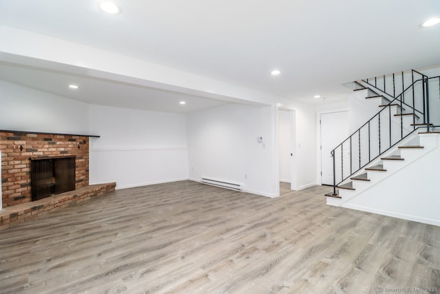 4 Deer Run Trl, Sherman, CT 06784 - unfurnished living room with a baseboard radiator, wood finished floors, recessed lighting, stairs, and a fireplace