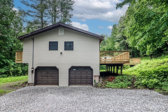 4 Deer Run Trl, Sherman, CT 06784 - view of home's exterior with gravel driveway, an attached garage, and a wooden deck