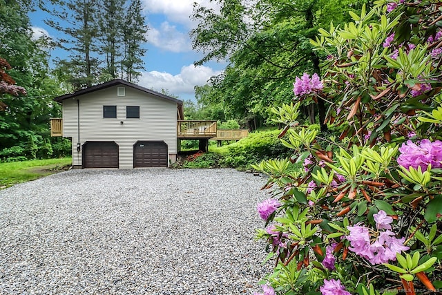 4 Deer Run Trl, Sherman, CT 06784 - view of side of home with an attached garage, a deck, and driveway