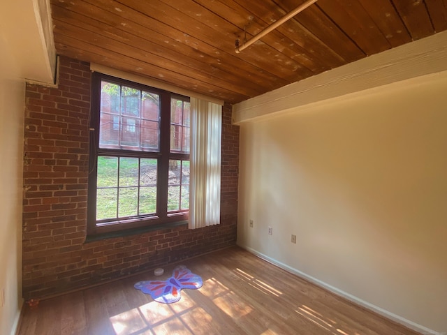839 Main St Apt 35, Torrington, CT 06790 - unfurnished room featuring plenty of natural light, wood finished floors, brick wall, wood ceiling, and baseboards