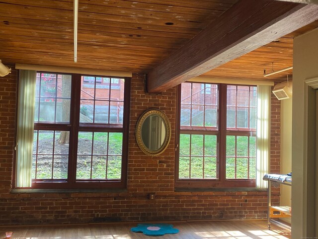 839 Main St Apt 35, Torrington, CT 06790 - detailed view of wood finished floors, brick wall, and wood ceiling with exposed beams