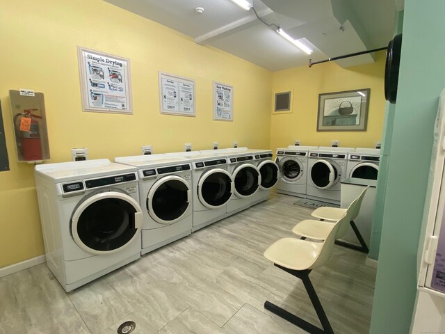 839 Main St Apt 35, Torrington, CT 06790 - community laundry featuring washer and clothes dryer, light wood-style floors, and baseboards