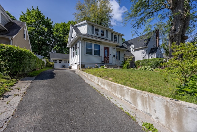 26 Herkimer St, Waterbury, CT 06710 - view of front of property featuring driveway, an outbuilding, and a front yard