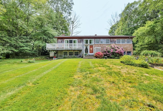 27 N Rd, Waterford, CT 06385 - view of front of house with a wooden deck, a front lawn, and a chimney