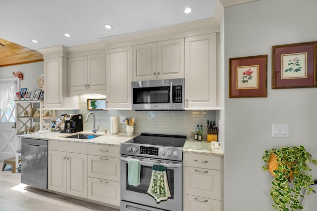 27 N Rd, Waterford, CT 06385 - kitchen with stainless steel appliances, a sink, backsplash, light stone countertops, and recessed lighting