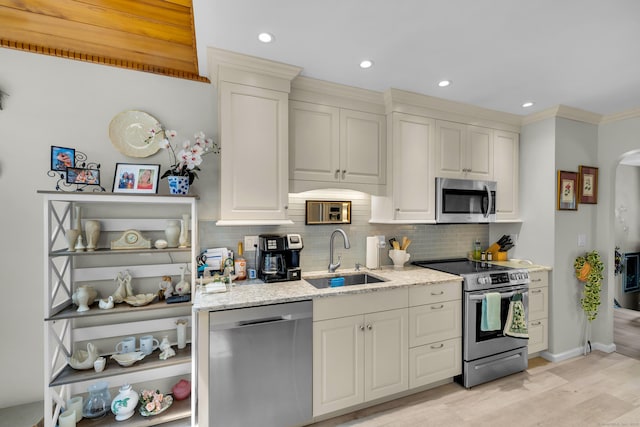 27 N Rd, Waterford, CT 06385 - kitchen featuring appliances with stainless steel finishes, a sink, decorative backsplash, light stone countertops, and recessed lighting