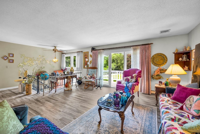 27 N Rd, Waterford, CT 06385 - living area featuring a textured ceiling, wood finished floors, and ceiling fan