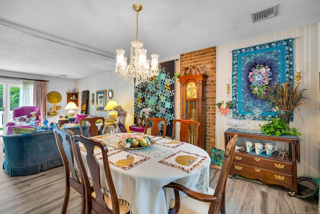 27 N Rd, Waterford, CT 06385 - dining space with wood finished floors, a chandelier, and a textured ceiling
