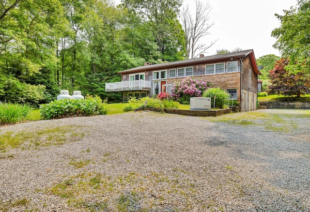 27 N Rd, Waterford, CT 06385 - view of front of property with driveway, a chimney, an attached garage, and a wooden deck