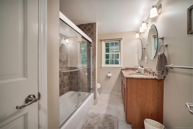 67 Great Hill Rd, Ridgefield, CT 06877 - full bathroom with vanity, tile patterned floors, toilet, shower / bath combination with glass door, and baseboards