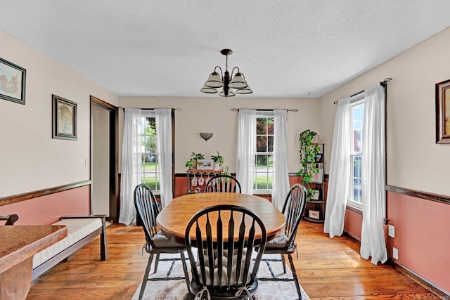 47 Edrow Rd, Bristol, CT 06010 - dining room featuring a chandelier, a textured ceiling, and light wood finished floors