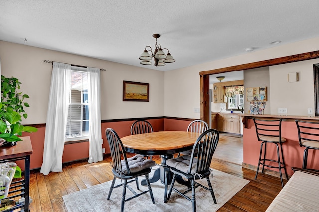 47 Edrow Rd, Bristol, CT 06010 - dining area with a chandelier, light wood finished floors, and a textured ceiling