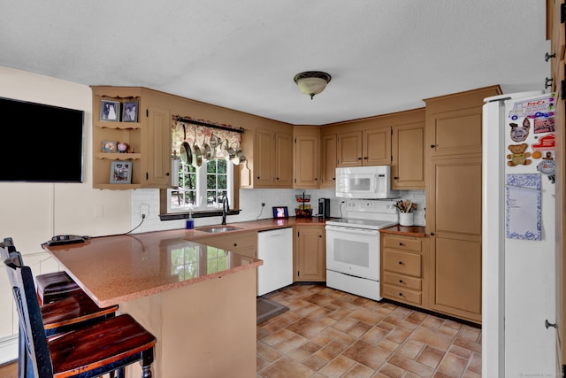 47 Edrow Rd, Bristol, CT 06010 - kitchen featuring white appliances, a peninsula, tasteful backsplash, and a breakfast bar