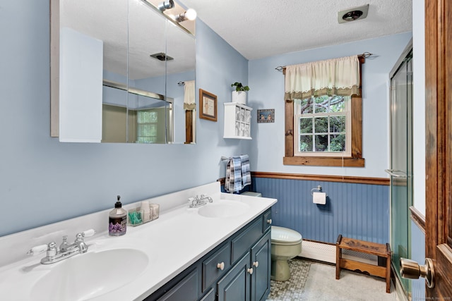 47 Edrow Rd, Bristol, CT 06010 - bathroom with a shower stall, a wainscoted wall, double vanity, and a textured ceiling