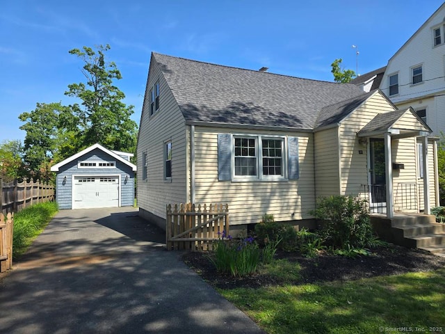 28 S Highland St, West Hartford, CT 06119 - view of front of home featuring an outdoor structure, driveway, a garage, and roof with shingles