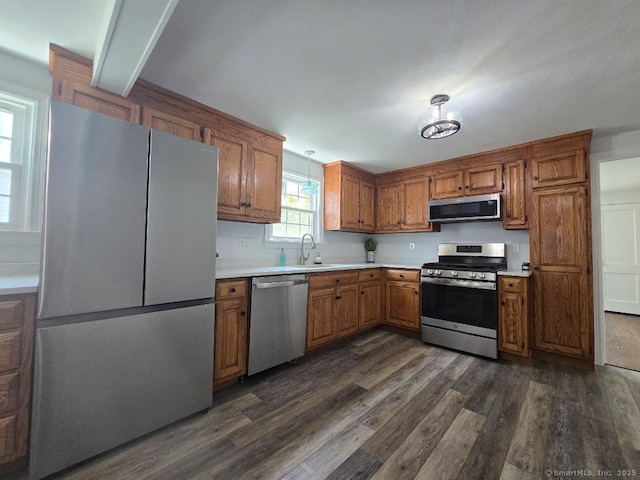 28 S Highland St, West Hartford, CT 06119 - kitchen featuring appliances with stainless steel finishes, dark wood-style flooring, a sink, brown cabinets, and light countertops