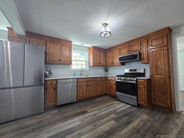 28 S Highland St, West Hartford, CT 06119 - kitchen featuring appliances with stainless steel finishes, brown cabinetry, and light countertops