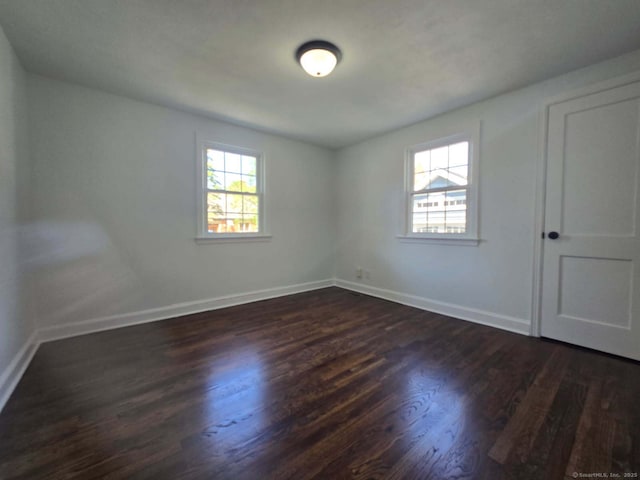 28 S Highland St, West Hartford, CT 06119 - empty room with plenty of natural light, dark wood-style floors, and baseboards