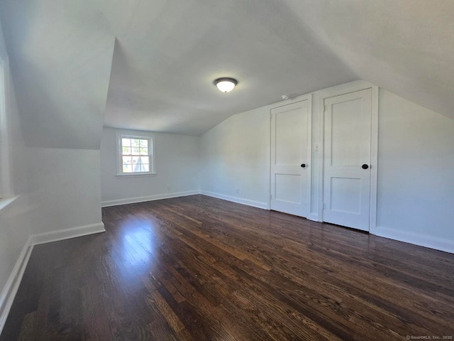 28 S Highland St, West Hartford, CT 06119 - additional living space with lofted ceiling, dark wood-style flooring, and baseboards