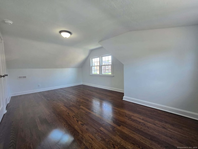 28 S Highland St, West Hartford, CT 06119 - additional living space with dark wood-style flooring, baseboards, and lofted ceiling