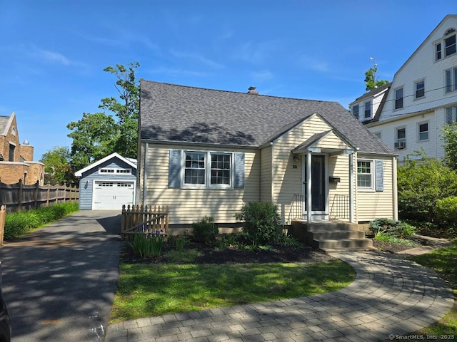 28 S Highland St, West Hartford, CT 06119 - view of front facade with driveway, an outdoor structure, a detached garage, a chimney, and a shingled roof