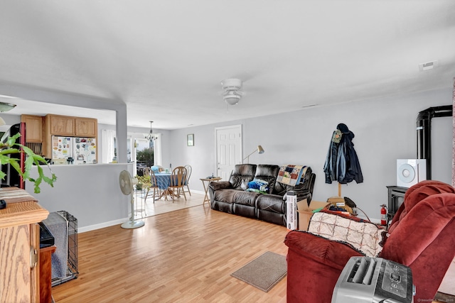 28 Kulper Rd, New Britain, CT 06051 - living area featuring ceiling fan, light wood-style flooring, baseboards, and a chandelier