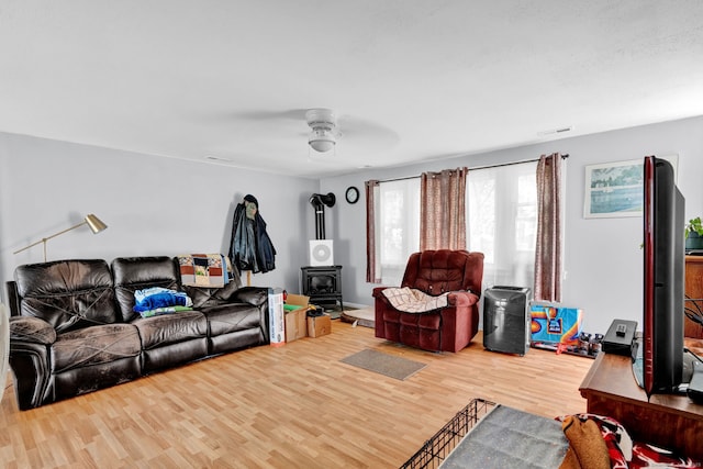 28 Kulper Rd, New Britain, CT 06051 - living area with a wood stove, wood finished floors, and a ceiling fan