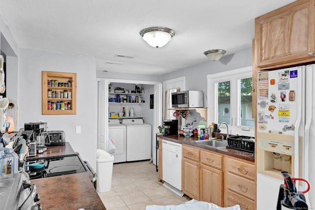 28 Kulper Rd, New Britain, CT 06051 - kitchen with white appliances, a sink, washer and dryer, dark countertops, and light tile patterned floors