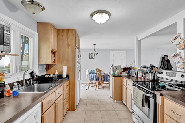 28 Kulper Rd, New Britain, CT 06051 - kitchen with appliances with stainless steel finishes, a sink, dark countertops, a chandelier, and light tile patterned flooring