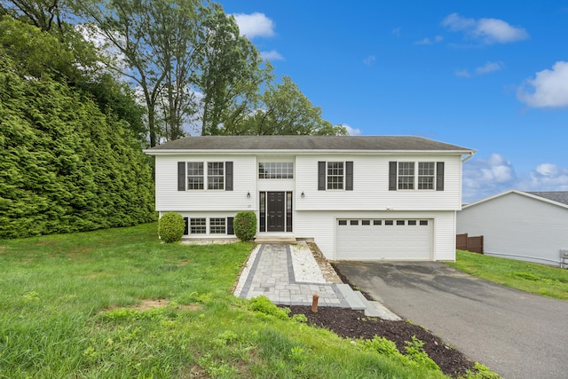 23 Shadybrook Ln, Waterbury, CT 06706 - raised ranch featuring asphalt driveway, a garage, and a front lawn