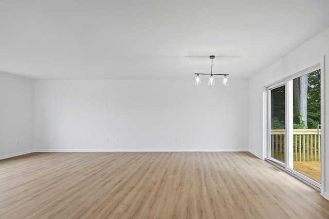23 Shadybrook Ln, Waterbury, CT 06706 - unfurnished room featuring light wood-style flooring and a chandelier